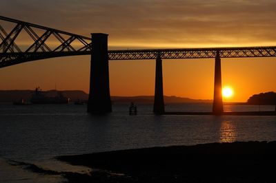 Silhouette of suspension bridge during sunset