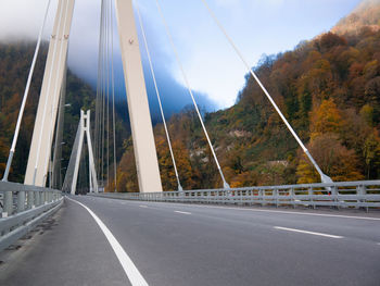 Road by bridge against sky