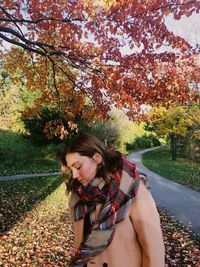 Beautiful young woman in park during autumn