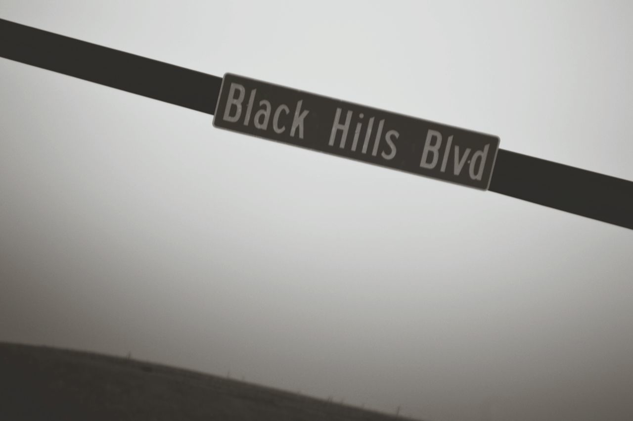 LOW ANGLE VIEW OF SIGN AGAINST CLEAR SKY