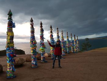 Rear view of people at temple against sky