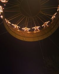 Low angle view of illuminated ferris wheel