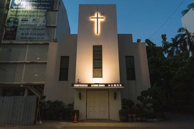 Low angle view of illuminated building against sky