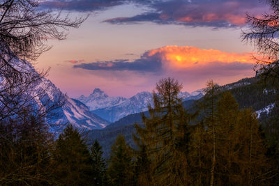 Scenic view of snowcapped mountains against sky during sunset