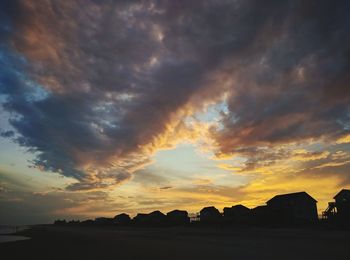 Silhouette of landscape against cloudy sky