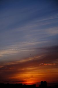 Scenic view of silhouette buildings against sky during sunset