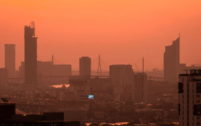 Air pollution. smog and fine dust of pm2.5 covered city in the morning with red sunrise sky. 