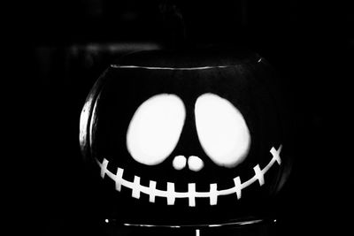 Close-up of illuminated pumpkin against black background