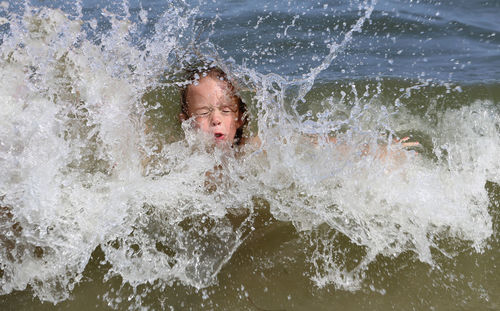 High angle view of boy playing in river