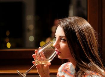 Close-up of beautiful woman having wine