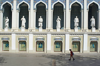 People walking in front of historic building