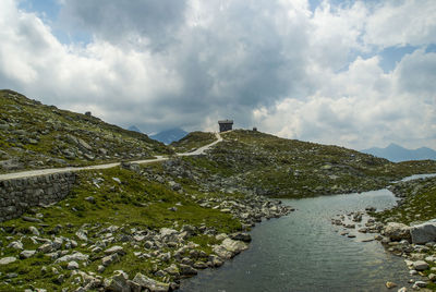 Scenic view of river amidst mountains against sky