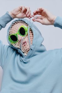 Cropped hand of woman with mask