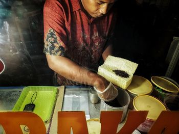 Midsection of man working on table