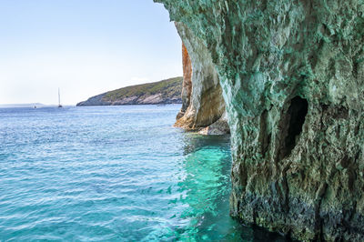 Rock formation in sea against sky