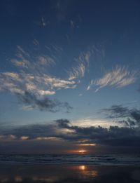 Scenic view of sea against dramatic sky during sunset