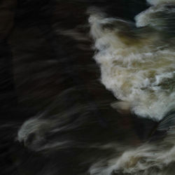 Close-up of waves against black background