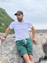 Portrait of young man standing at beach