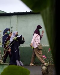 Rear view of people standing outdoors