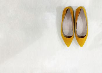 High angle view of yellow paint on white wall