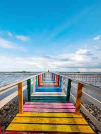 View of empty bridge over sea against sky. rainbow bridge and seaside bridge, bright colors.