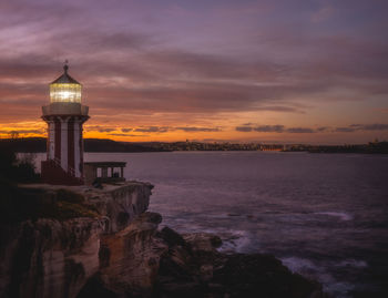 Twilight long exposure of iconic lighthouse on coastal cliff edge