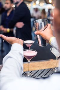 Midsection of bartender making cocktail in bar