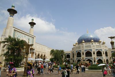 Group of people in front of historic building against sky