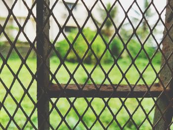 Close-up of chainlink fence against sky