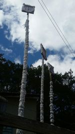 Low angle view of street light against sky