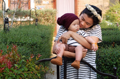 Woman with baby by plants