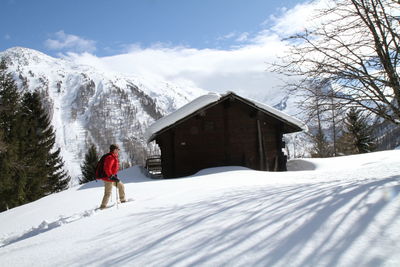 Full length of person on snowcapped mountain against sky