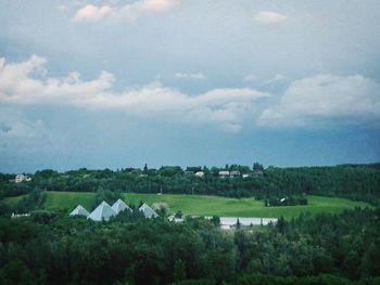 Scenic view of field against cloudy sky