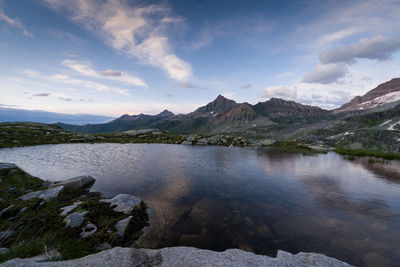 Reflections on a lake at sunset in the alpes