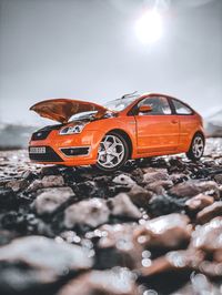 Close-up of toy car on land during sunny day