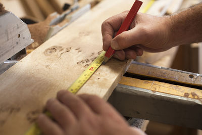 Midsection of carpenter working in workshop