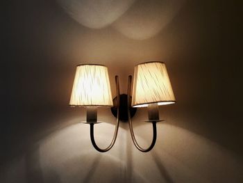 Lit lamp hanging on ceiling