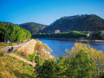 Scenic view of lake against clear blue sky