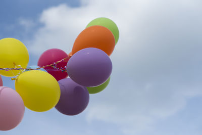 Low angle view of balloons against sky