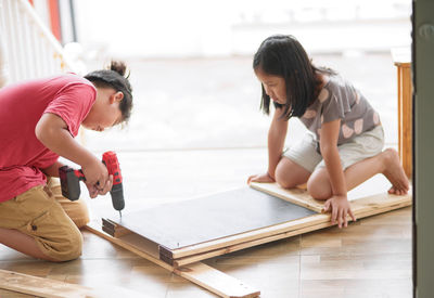 Girls working with on wood at home