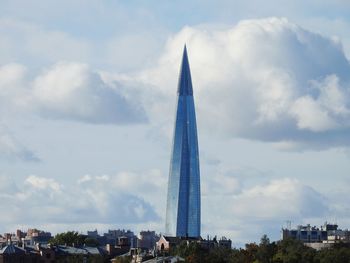 Low angle view of buildings against cloudy sky