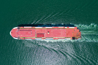 High angle view of red ship sailing on sea