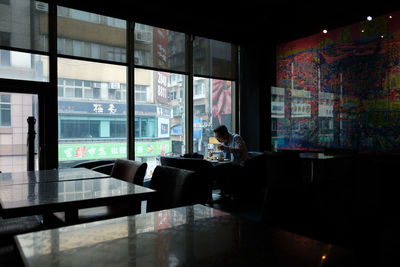 Man sitting on table in restaurant