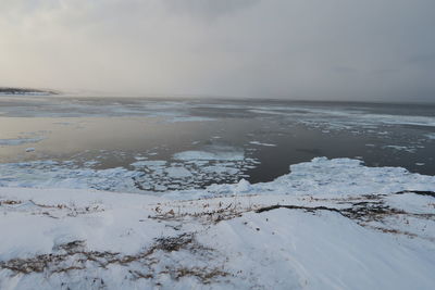 Scenic view of sea against sky during winter