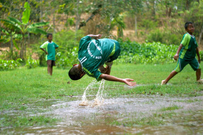 Full length of men running in water