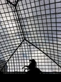 Low angle view of silhouette man against ceiling