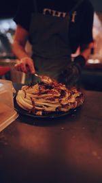 Midsection of person preparing food in kitchen