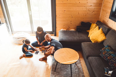 Rear view of woman sitting on sofa at home