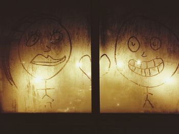 Close-up of illuminated lamp at sunset