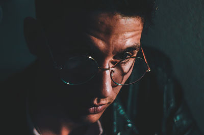 Close-up portrait of young man wearing eyeglasses